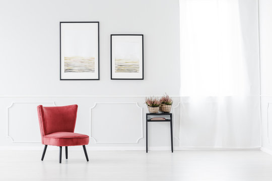 Red armchair against white wall