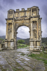 Arch of Caracalla in roman town Cuicul at village Djemila, Algeria