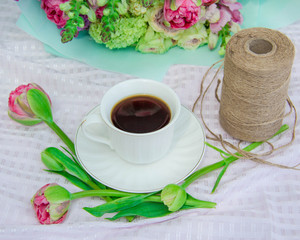 bouquet on a table a cup of coffee