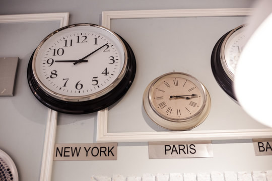 international clock with different time zone for New York and Paris are hang on the wall
