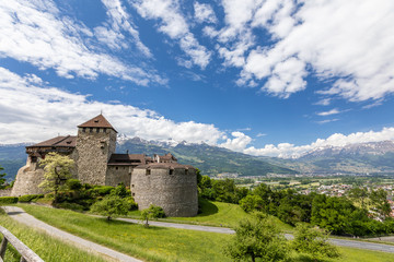 Fototapeta na wymiar Vaduz Castle with mountain road in Liechtenstein. Alps landscape