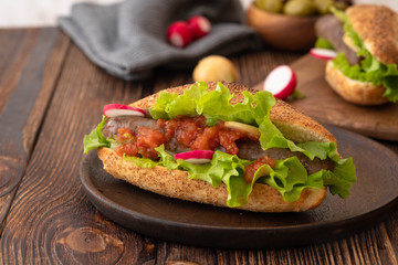 Hot dog with sausage grill, fresh vegetables and sauce.