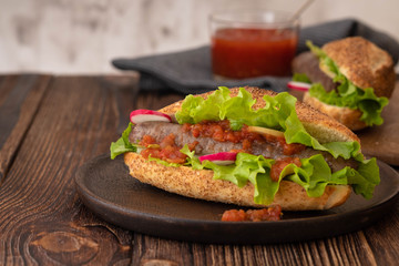 Hot dog with sausage grill, fresh vegetables and sauce.