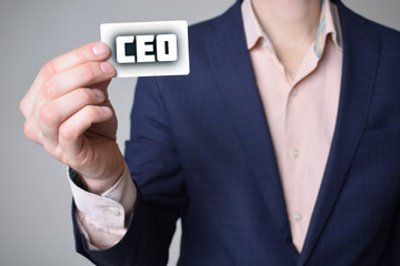 Businessman shows business card with the inscription:CEO