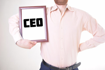 A businessman shows an inscription:CEO