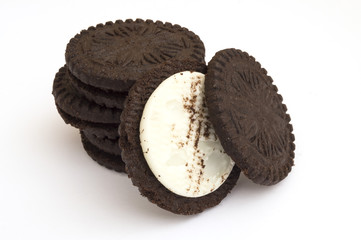 chocolate cookies filled with cream on white background