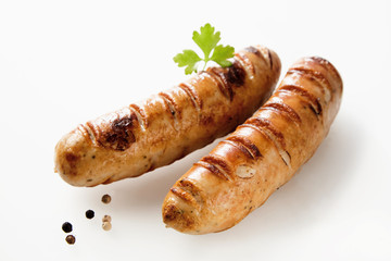 Two seared barbecued bratwurst with copy space