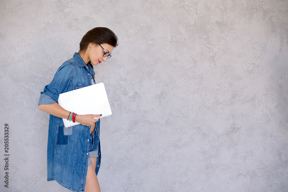 Wall mural Young woman profile holding noutbook