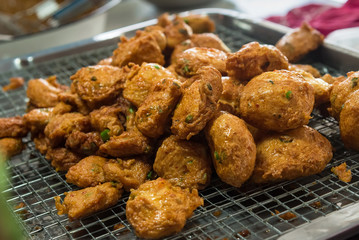 Deep fried Curry paste ocean fish or Fish curry pancake in Taling Chan Floating Markett at Bangkok, Thailand.
