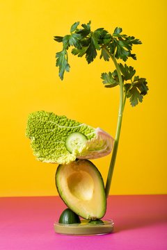 A vegetable sculpture against a coloured background