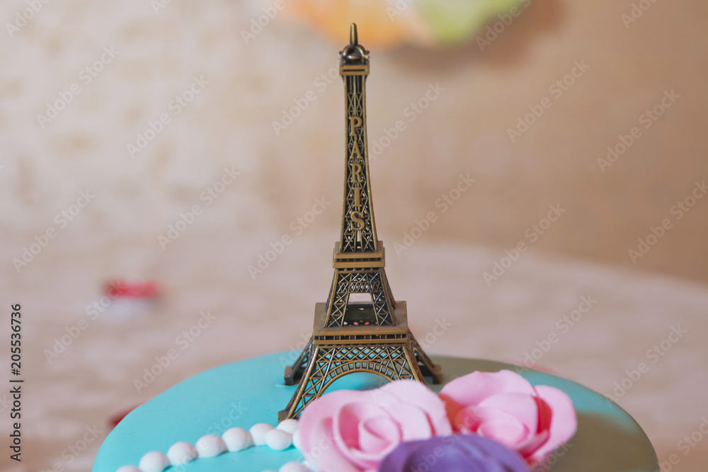 Wall mural Eiffel tower souvenir toy, isolated on a yellow background