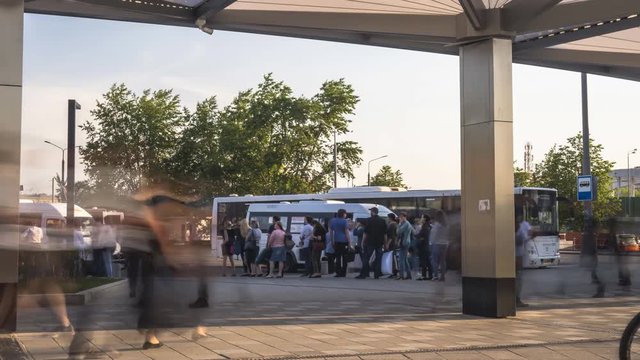 passengers waiting and boarding buses at the bus terminal, time lapse