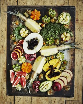 Various fruits on a vintage tray Healthy greens