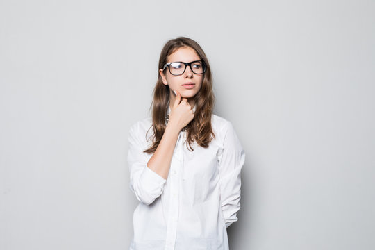 Beautiful thinking business woman isolated gray background