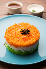 Tricolor Tiranga Rice for indian Republic and Independence day, served in a blue plate, selective focus