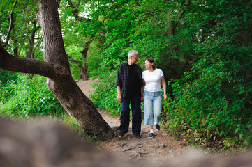Fototapeta premium Senior couple walking together in a forest, close-up