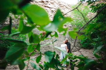 Active loving senior couple walking in beautiful summer forest - active retirement concept