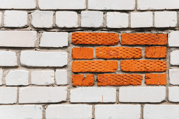 White brick wall background with orange rectangle.