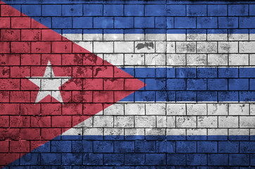 Cuba flag is painted onto an old brick wall