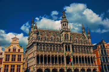 Fototapeta na wymiar Richly decorated facade in Gothic style of Brussels City Museum and Belgian flag. Vibrant and friendly, is the country’s capital and administrative center of the EU. Central Belgium. Retouched photo
