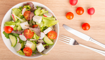 cheese salad in a bowl top view.