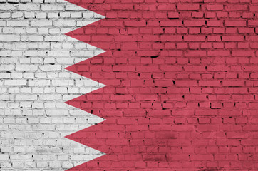 Bahrain flag is painted onto an old brick wall