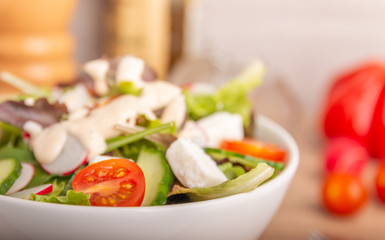 cheese salad in a bowl on a wooden table
