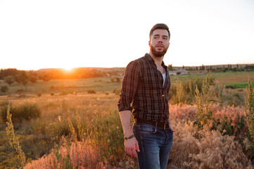 Handsome man on sunset background