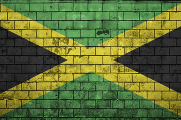 Jamaica flag is painted onto an old brick wall
