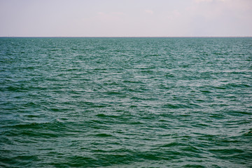 Fototapeta premium the blue ocean with dull clouds on a lovely sunny day