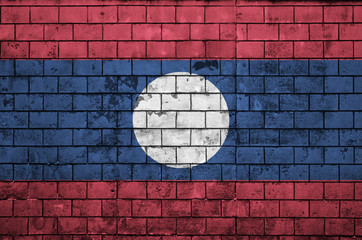 Laos flag is painted onto an old brick wall