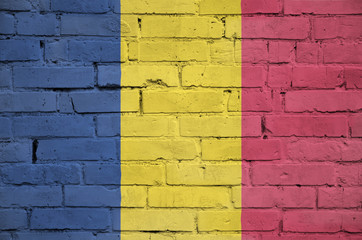 Chad flag is painted onto an old brick wall