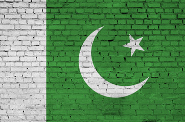 Pakistan flag is painted onto an old brick wall