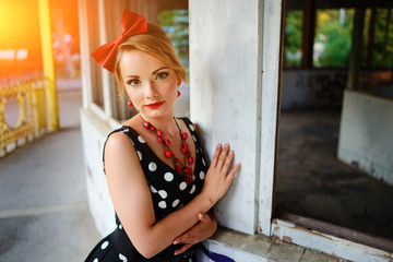 beautiful young woman posing in retro dress