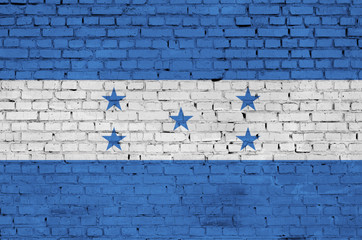 Honduras flag is painted onto an old brick wall