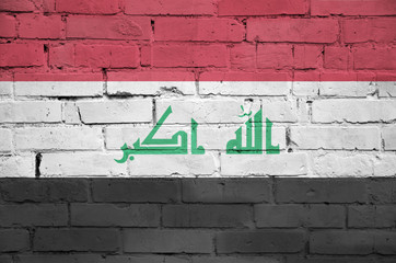 Iraq flag is painted onto an old brick wall
