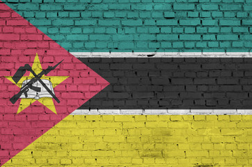 Mozambique flag is painted onto an old brick wall