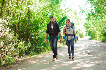 A young couple is traveling with backpacks