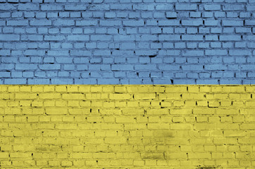 Ukraine flag is painted onto an old brick wall