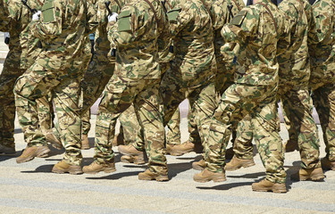 Soldiers are marching at the military parade.