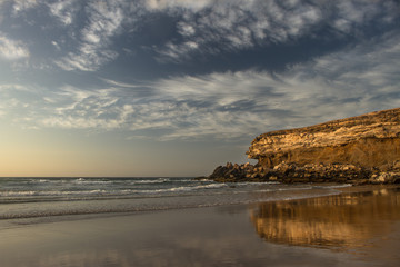 Gold sunset on sandy beach of Atlantic ocean, Fuerteventura, La Pared.