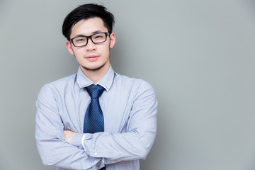 Portrait charming handsome businessman: Attractive guy wears eyeglasses, shirt, necktie. Asian man looks confident. He crossed arms and looks smart. Business men get successful of business. copy space