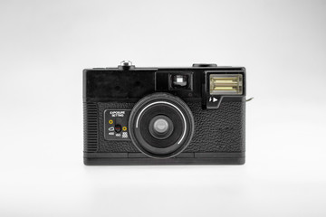 Old fashioned vintage style film camera for professional photography is a retro fashion look on a white background isolated.