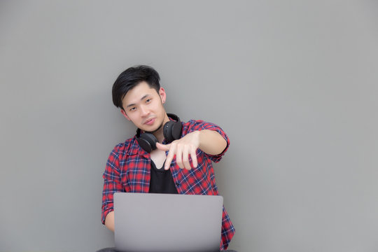 Portland handsome programmer guy: Attractive man is using internet online on notebook computer. Charming handsome young man feels happy and cheerful because he gets successful of his work. copy space