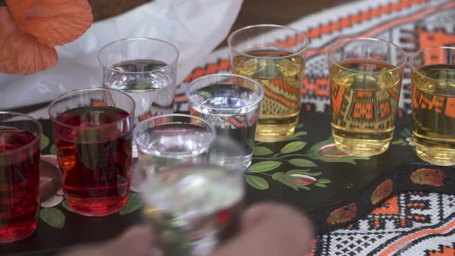 Man take a shot of Colorful Hard Alcohol on traditional Ukrainian wedding