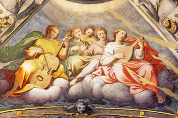 REGGIO EMILIA, ITALY - APRIL 12, 2018: The Fresco of angels with the music instruments in cupola of...
