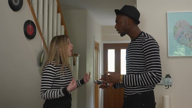 Wearing the same clothes couple young. Slow dolly shot of young couple wearing the same clothes and arguing over the issue, man gets told off