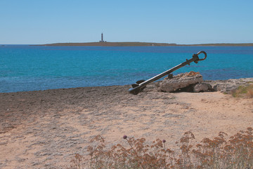 Fototapeta na wymiar Ancient ship anchor and sea gulf. Punta Prima, Minorca, Spain 