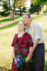 Happy elderly couple at nature