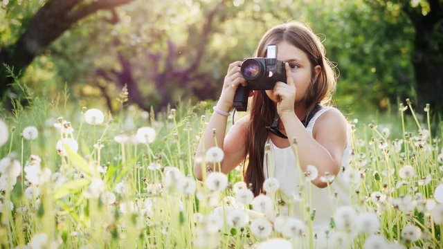 Girl photographer of twelve years takes pictures of nature. Slow Motion